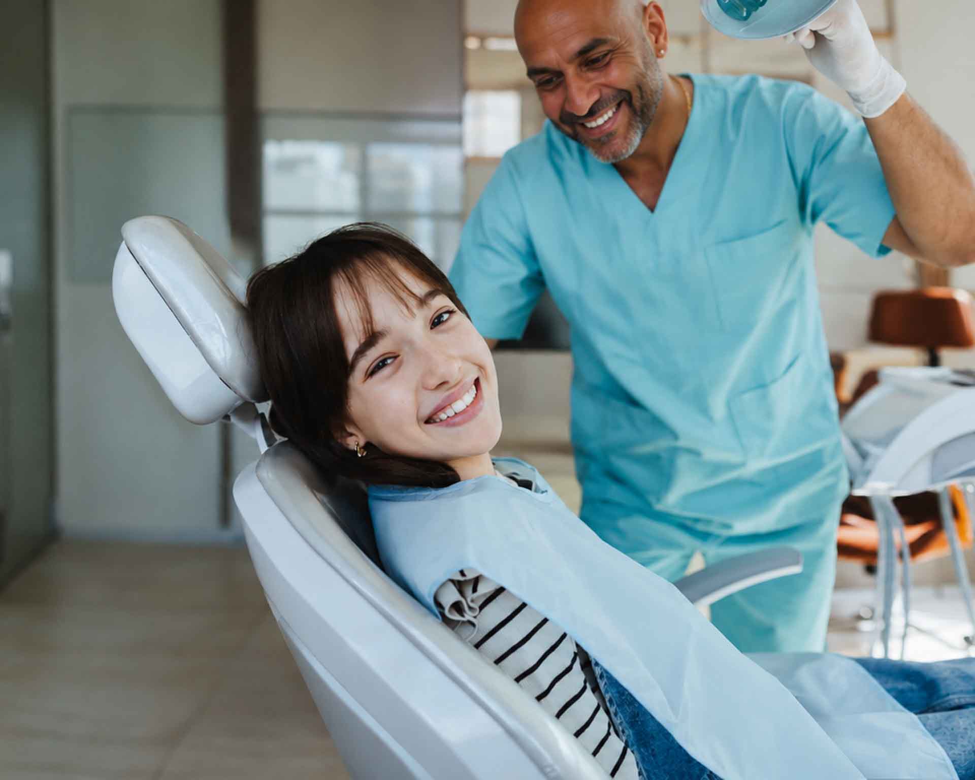 Cheerful Dental Visit with Dentist and Patient with Milan Sata DDS Grand Blanc Dental Center in Grand Blanc, Michigan