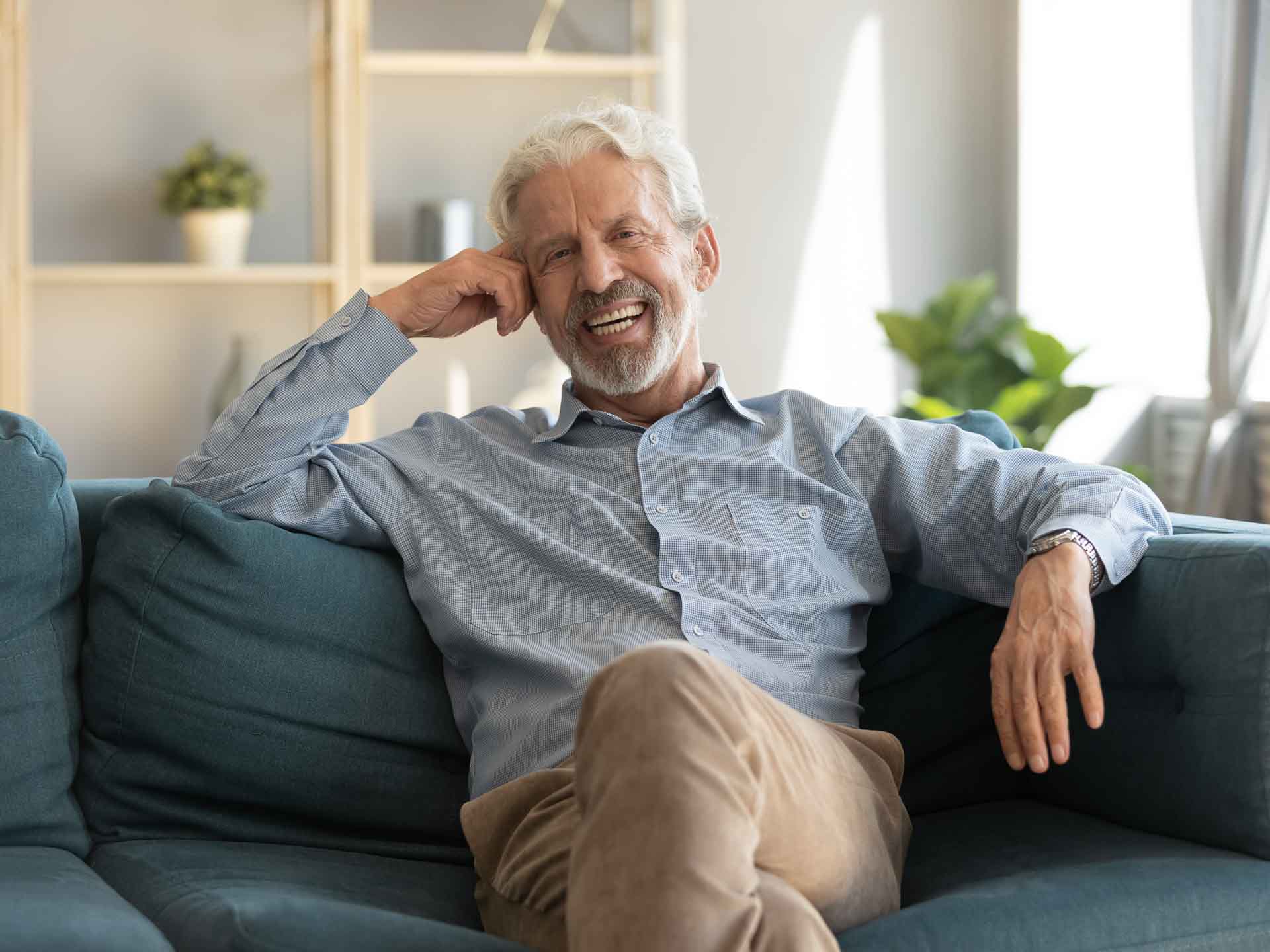 Mature man smiling confidently representing dental implant treatment in Grand Blanc, Michigan