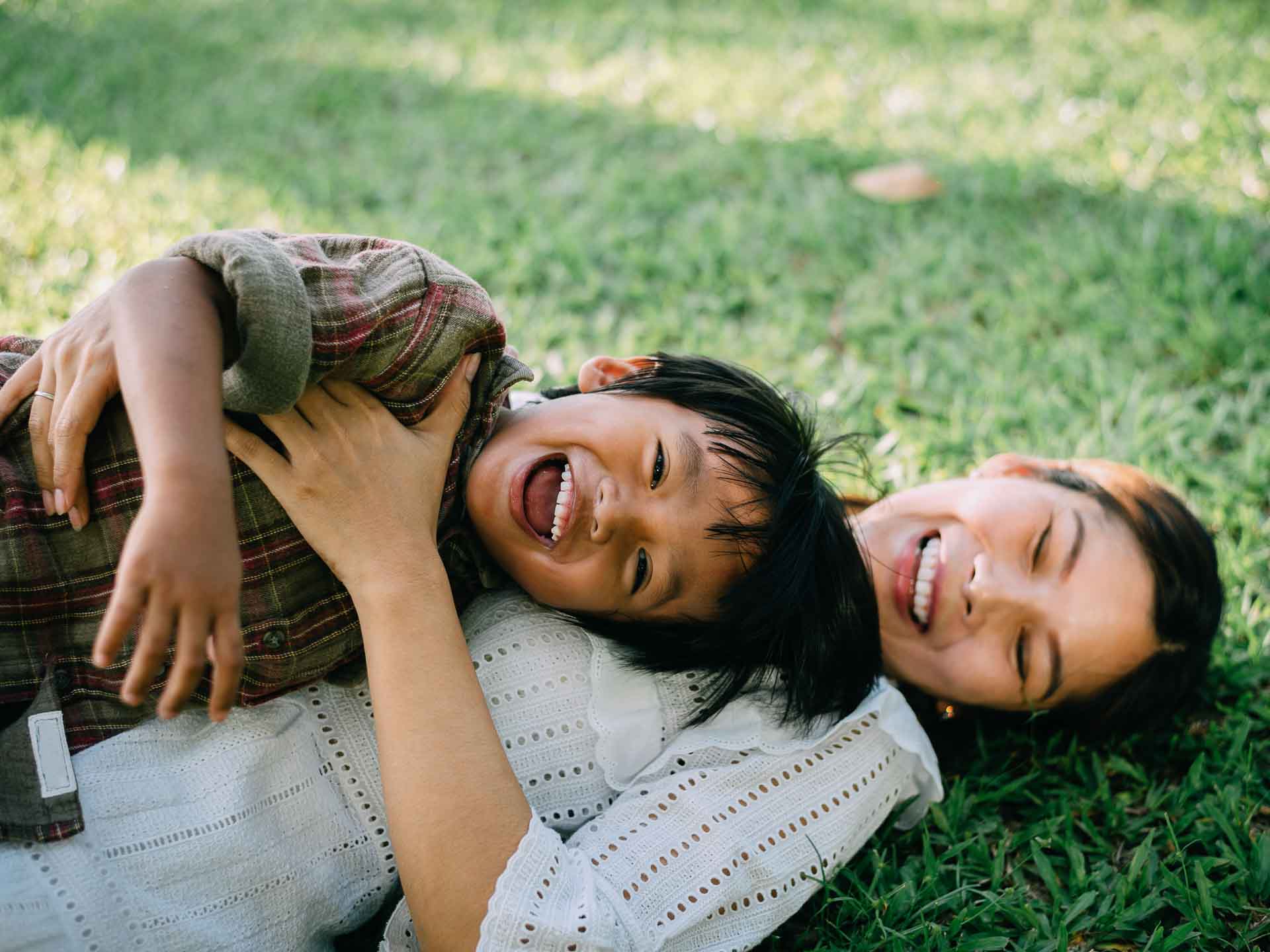 Mother and child smiling together, representing supportive pediatric dental care for families in Grand Blanc, Michigan